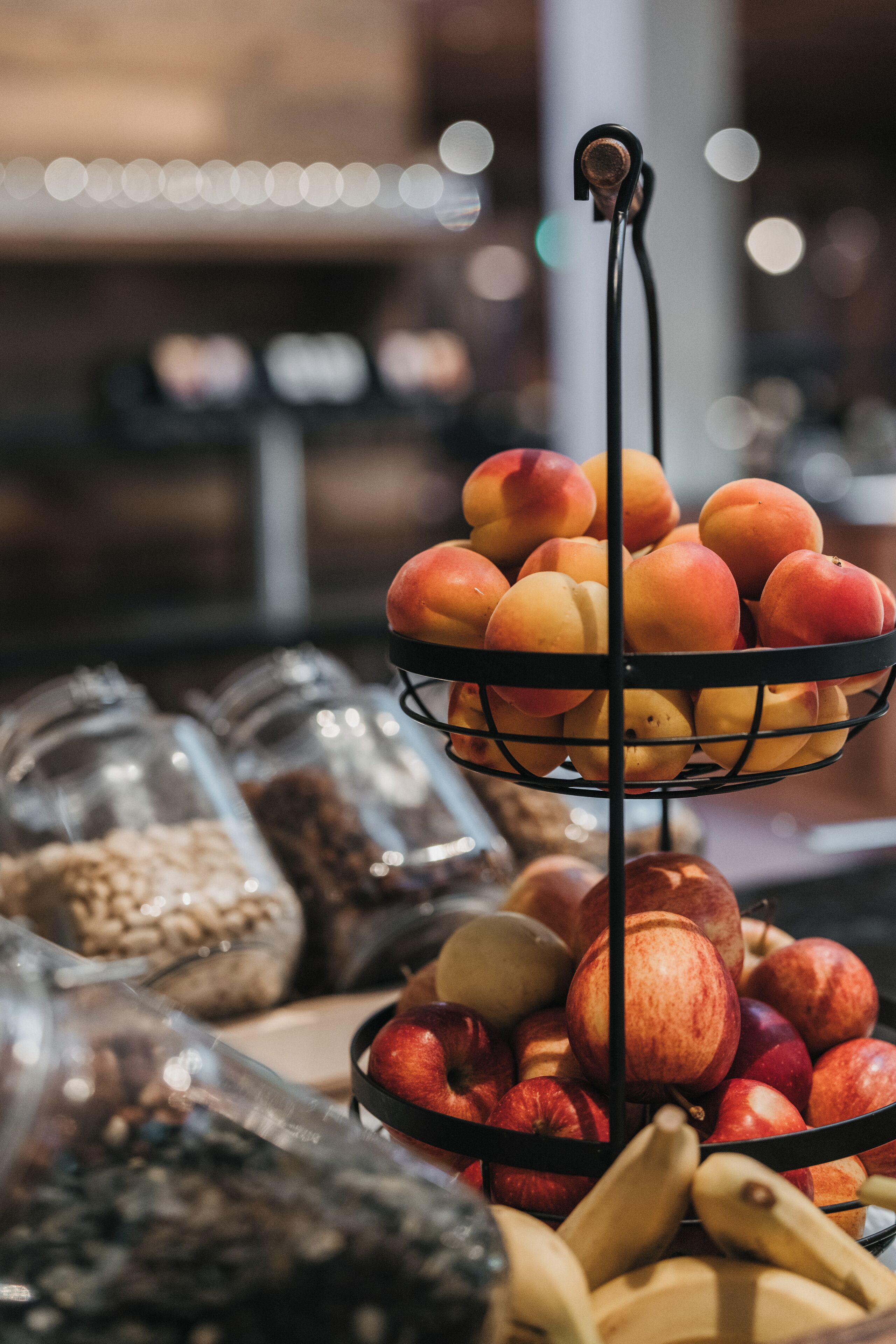 A fruit display with peaches and apples.
