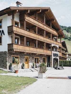 A multi-story wooden building with balconies, a stone facade, and a sign reading 'VAYA'. - VAYA Gerlos (Gerlos)