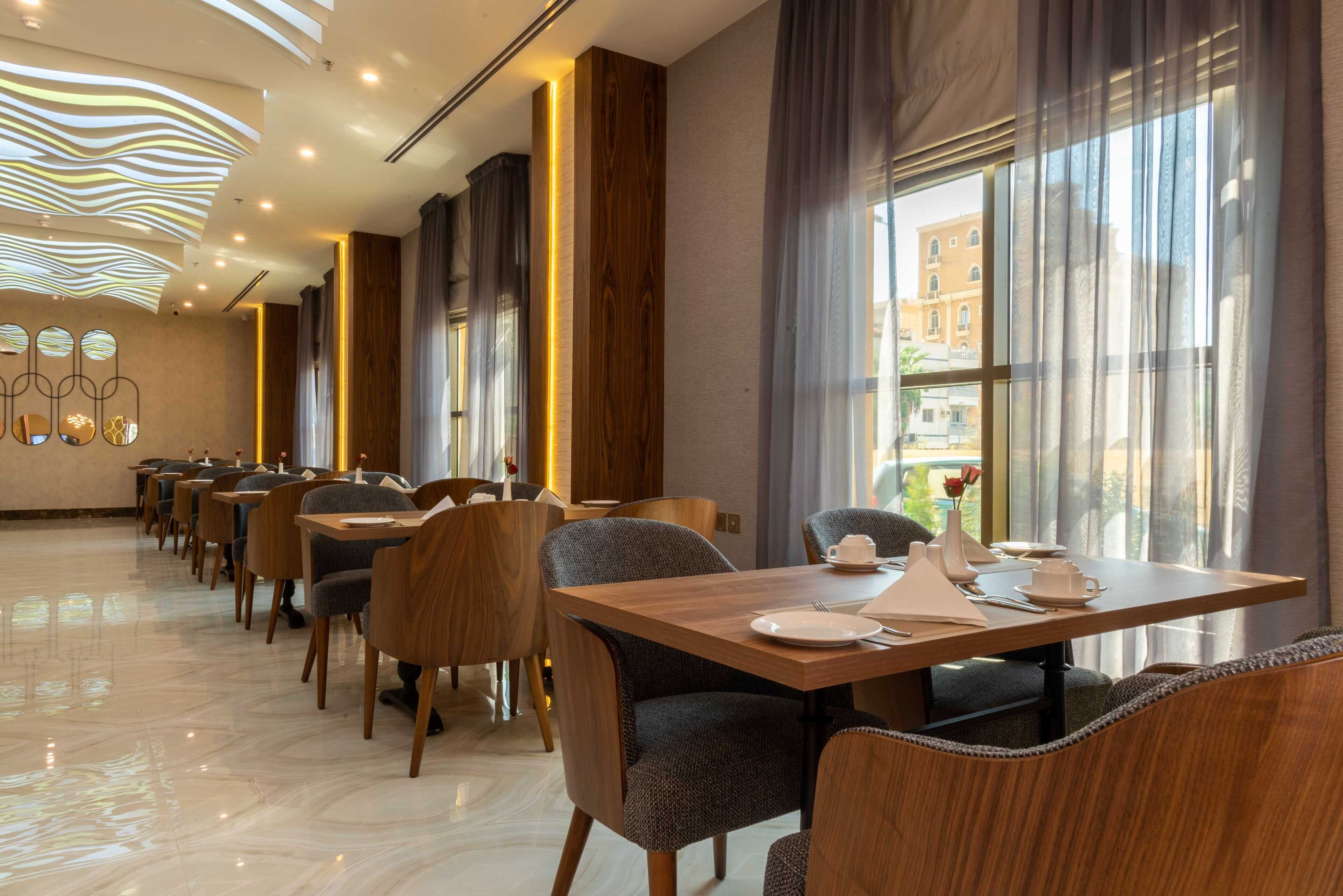 Un comedor moderno con una mesa larga, sillas y vistas a edificios.
