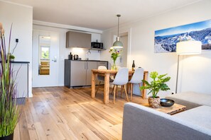 A modern apartment with a kitchen, dining area, and living space.
