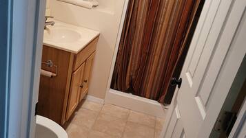 Combined shower/bathtub, towels, soap, toilet paper