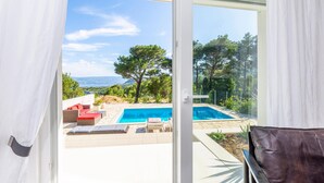 A pool area with a clear view of the surrounding landscape, including trees and distant hills. - Amazing Home in Naklice With Wifi and 2 Bedrooms (Omis)