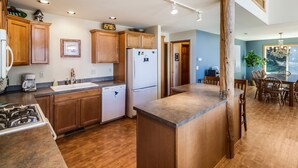 A modern kitchen with wooden cabinets, a built-in dishwasher, and a central island. - Waterfront w/ Seasonal Dock! (Rendezvous Retreat) (Friday Harbor)