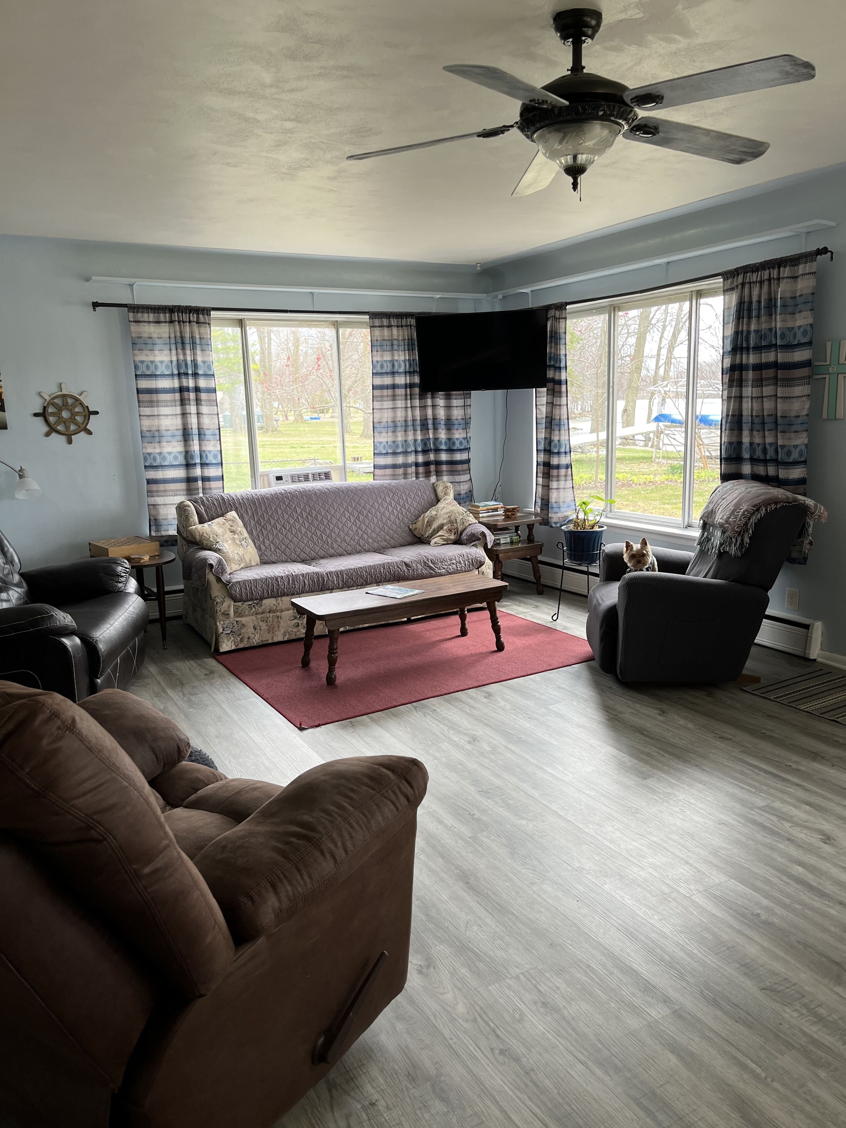 A living room with a sofa, armchair, and a coffee table.