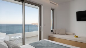 A modern bedroom with a large sliding glass door leading to a balcony with a sea view. - Ode Iconic Residence, forever in blue - Best Villa (Bali)