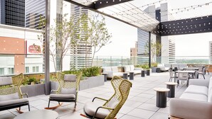 A rooftop lounge with seating, tables, and a view of the cityscape. - Hyatt Centric Downtown Denver (Denver)