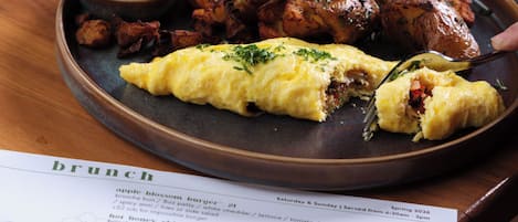 A meal with a plate of food, a cup, and a menu.