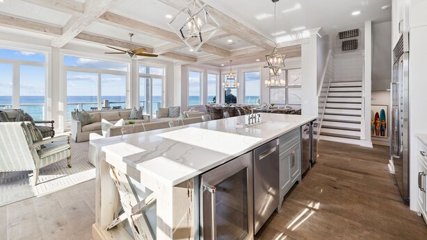 A spacious kitchen with a large island, modern appliances, and a view of the ocean. - Luxe group-friendly beachfront escape with pool, hot tub, & expansive Gulf views (West Panama City Beach)