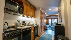 Une cuisine avec des meubles en bois, un four à micro-ondes, une cuisinière et un lave-vaisselle.