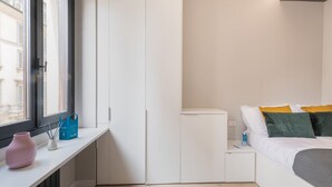 A bedroom with a bed, bedside table, and a window. - Sweett | Duomo V - One Bedroom Apartment, Sleeps 3 (Milano)