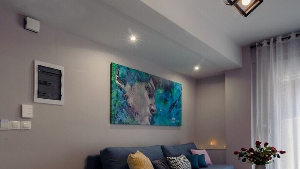 A modern living room with a blue sofa, a wooden coffee table, and a painting on the wall. - Athens Chic House Apt A3 40sq.m (Athina)