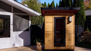 A wooden cabin with a door, a window, and a small porch area. - Rondout Retreat: Private Poolside Luxury with Hot Tub, Sauna and Fire Pit (Rosendale)