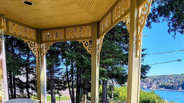 A covered outdoor area with wicker furniture and potted plants. - Plan for summer fun and fall color viewing.  Plenty of room for the family. (Hancock)