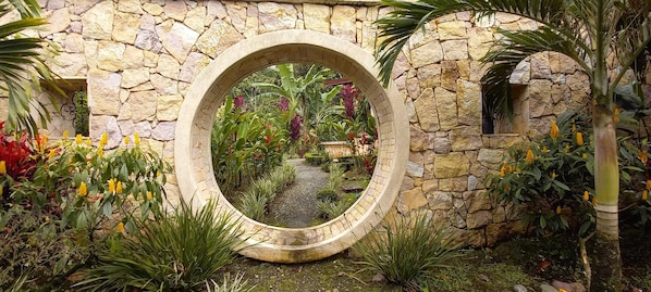 A stone archway with a garden view.