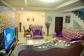 House | Living room | 30-inch TV with digital channels, fireplace - Furnished 4 Beds Semi-det House in Abuja, Nigeria (Lagos)