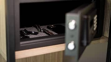 A black microwave with a control panel and a compartment containing keys.