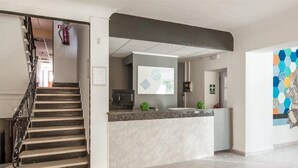 A modern interior with a staircase, a kitchen area, and a colorful mural. - Marigna (Ibiza Town)