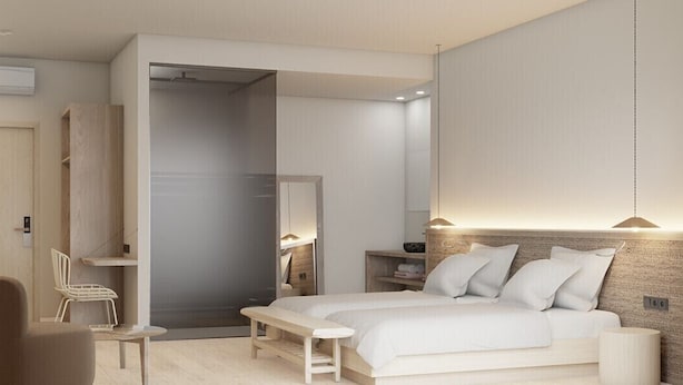 A modern bedroom with a bed, bedside tables, a chair, and a wardrobe. - Marigna (Ibiza Town)