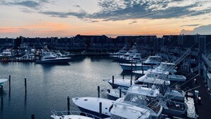 A marina with boats docked, surrounded by residential buildings. - Luxury Waterfront Condo  (Ocean City)