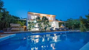 A modern two-story house with a swimming pool, outdoor seating, and a covered patio area. - Villa Evergreen with Pool (Crikvenica)