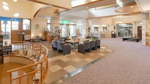 A spacious lobby with a central seating area, a staircase, and a reception desk. - Hotel Koryu (Fujikawaguchiko)