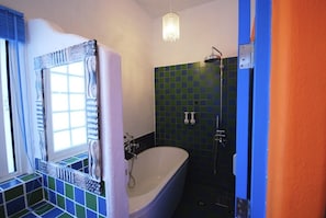 A bathroom with a freestanding bathtub, a shower, and a window with curtains. - Bethlehem B&B & Villa Kenting (Hengchun)
