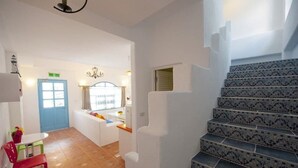 A staircase with patterned tiles leading to a landing.
