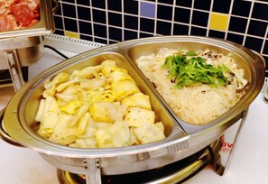 A buffet with various dishes including pasta, noodles, and a salad with greens. - Bethlehem B&B & Villa Kenting (Hengchun)