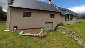 A single-story house with a sloped roof, a small porch, and a front door. - House with breathtaking view of the mountains (Adast)