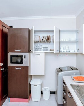 Fridge, microwave, cookware/dishes/utensils, dining tables