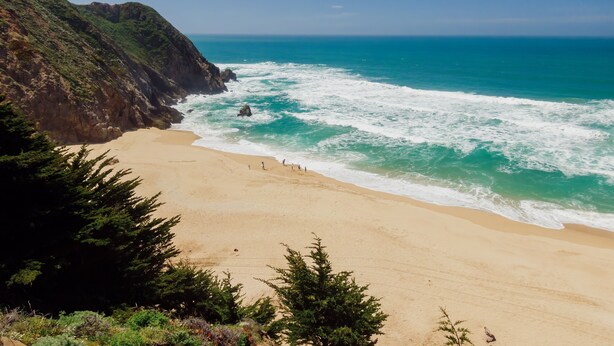 A beach with a rocky cliff and ocean waves. - Serene Canyon Private Villa•Pool•HotTub•Sauna Retreat STR Permit Number:14614552 (Pacifica)