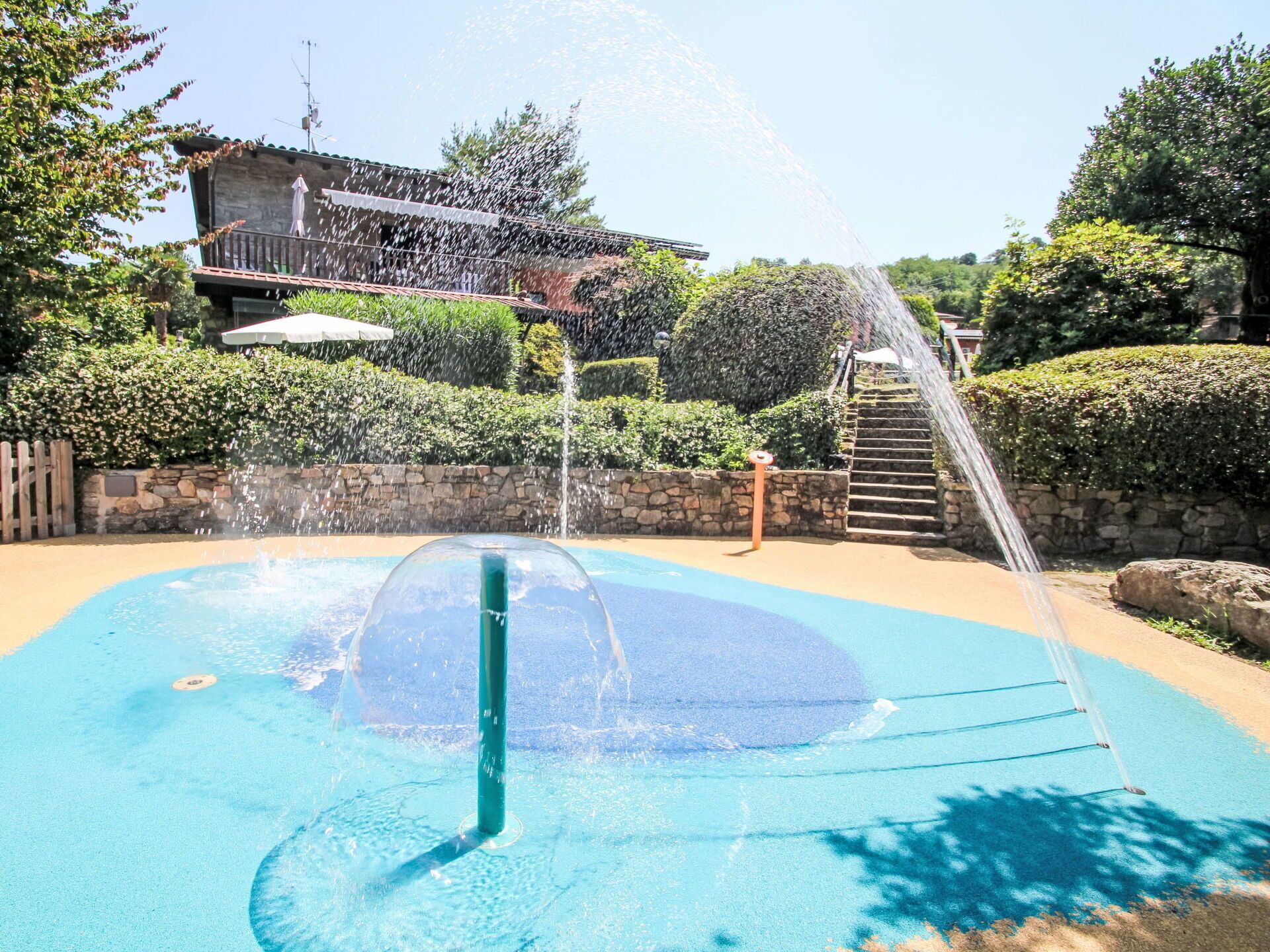 A water feature with a fountain in the center, surrounded by a pool.