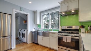 A modern kitchen with stainless steel appliances, a dishwasher, and a stove. - Chic Dover Home w/ Hot Tub: 1 Mi to Golf! (West Dover)