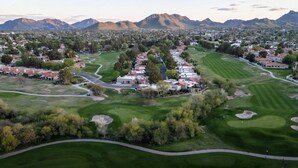 An aerial view of a golf course with residential buildings, roads, and mountains in the background. - Paradise Valley Paradise/ Ground Unit/Fresh Remodel (Phoenix)