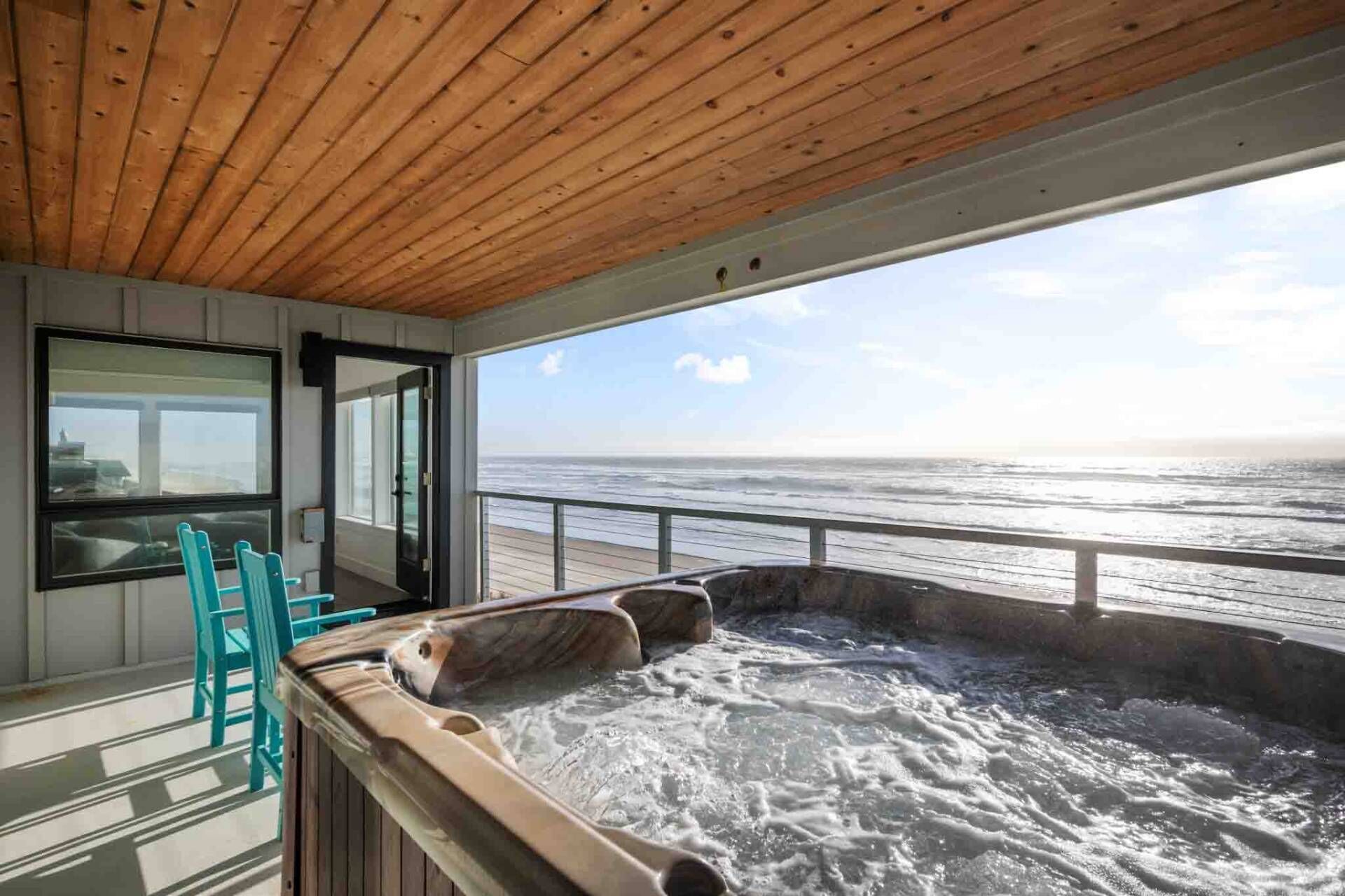 Un jacuzzi sur un balcon avec vue sur l’océan.