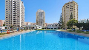 A swimming pool with high-rise buildings in the background.