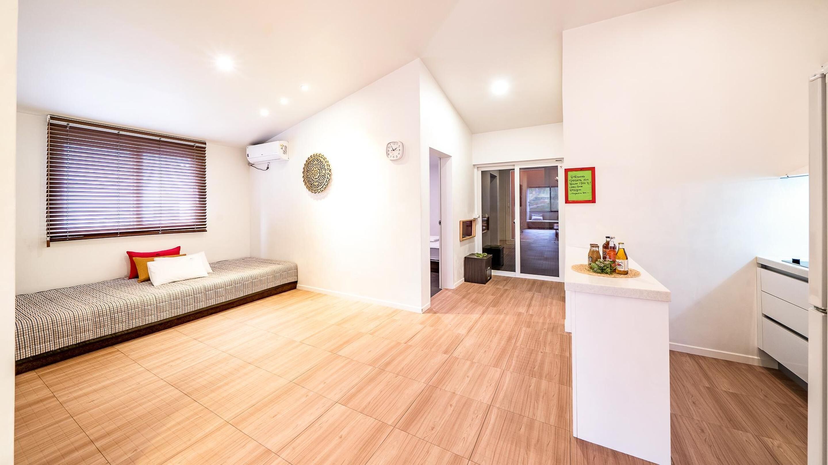 Un apartamento moderno con sala de estar, kitchenette y un pequeño comedor.