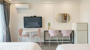 A hotel room with a bed, a desk with two chairs, a television, a mirror, and a refrigerator. - Yangyang Haetteuneun Changmun Pet-friend (Yangyang)