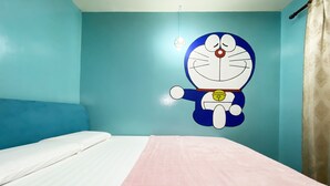 A room with a bed, a wall with a cartoon character, and a hanging light fixture. - Hotel O Pogimpaan Homestay (Ranau)