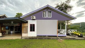 A two-story building with a purple roof and a covered porch. - Hotel O Pogimpaan Homestay (Ranau)