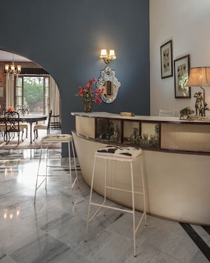 Enjoy a stylish space with a curved bar, comfortable seating, and a dining area.