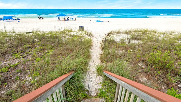 A beach path leading to the ocean with a wooden railing, sandy beach, and a few umbrellas. - ☀️Beach Front-Pool + HotTub-Latitude 29 #2☀️ (Panama City Beach)