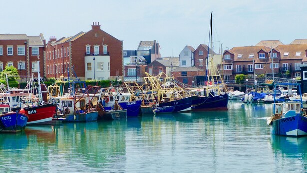 A harbor with boats docked, buildings in the background, and calm water. - One bedroom balcony apartment with allocated parking close to Gunwharf Quays (Portsmouth)