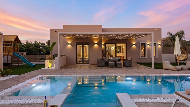 A modern house with a swimming pool, patio furniture, and a slide. - Koin Villa Sunset,  With Heated Pool & Whirlpool (Perama, Rethymno)