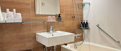 A modern bathroom with a white sink, a glass shower enclosure, and a bathtub.
