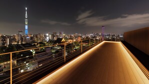 A nighttime cityscape with illuminated buildings and a prominent tower. - The Kanzashi Tokyo Asakusa (Tokyo)