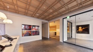 A modern interior with a wooden ceiling, a reception desk, and artwork on the walls. - The Kanzashi Tokyo Asakusa (Tokyo)