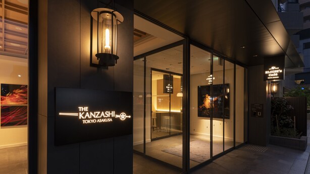 A modern building exterior with glass doors, a sign for "The Kanzashi Tokyo Asakusa," and a visible interior space with seating and a counter. - The Kanzashi Tokyo Asakusa (Tokyo)