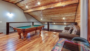 A wooden ceiling with a pool table and a sofa in a room with a view. - Easy Access • No Steep Roads • Near Parkway • Hot Tub • Arcade • 3 Master Suites (Pigeon Forge)