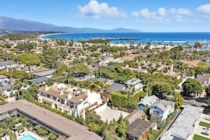 An aerial view of a coastal residential area with houses, a beach, and a pier. - Historic West Beach Apartment — 2 blocks to the Beach (Santa Barbara)